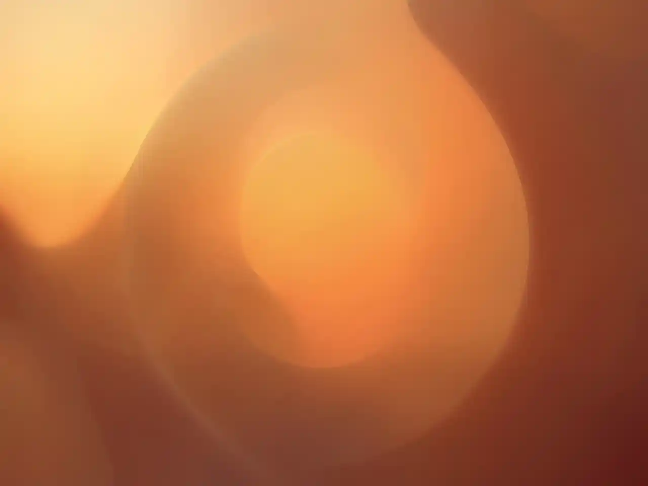 Warm evening tones with soft circular shapes suggesting calm and rest